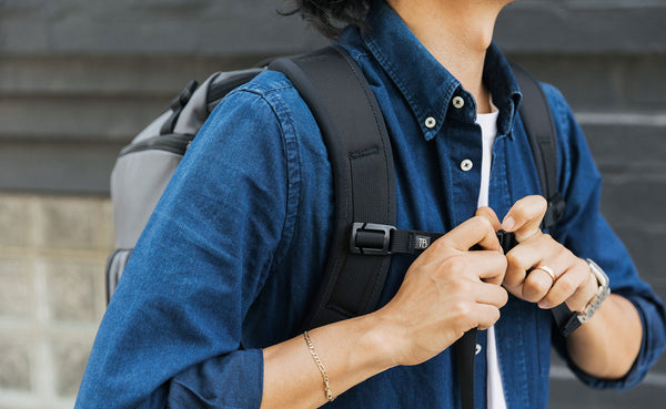 A person clipping the sternum strap on the Techonaut 45 closed.